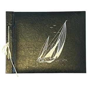 Vintage photo album with vintage mountain corners. Sailboats
